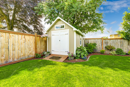 Beautiful new shed with flower bed on backyard areaの写真素材