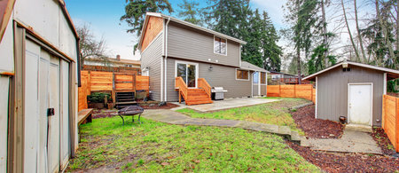 Nice back yard with patio, grass, and walkway.