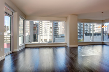 Large empty living room with fireplace and hardwood floor.の写真素材