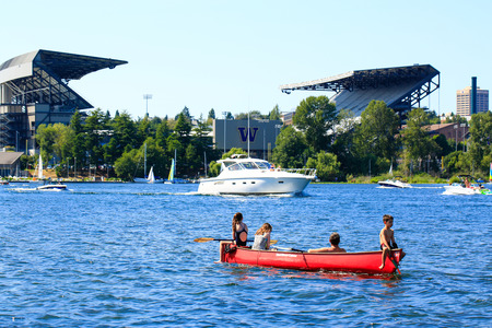 Seattle, WA - March 23, 2011: Children on the boat, University of Washington - Husky Stadium  at the backgroundのeditorial素材