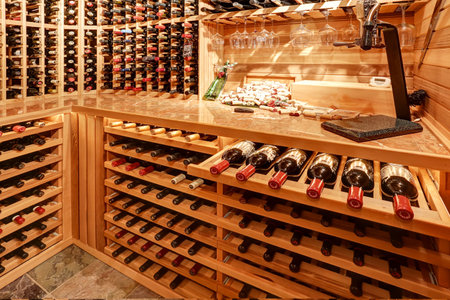Bright home wine cellar with wooden storage units and arch with bottles. Northwest, USA