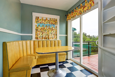 Classic dining room with blue walls, tile floor and exit to balcony. Northwest, USAの写真素材