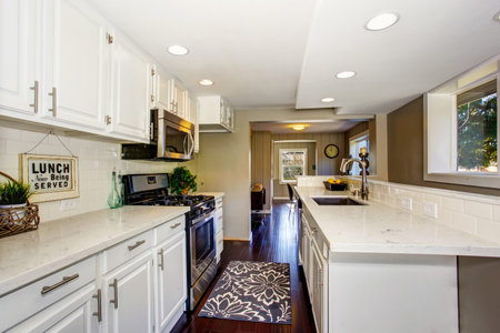 Classic American kitchen room interior with white cabinets and hardwood floor. Northwest, USA
