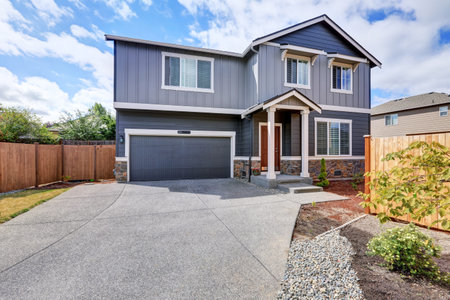 Gray house exterior with white column porch and long driveway. Tacoma. Northwest, USA