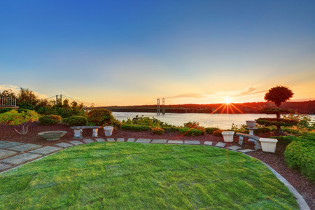 Luxury house exterior at sunset. Perfect landscape design. Scenic water view. Northwest, USAの写真素材