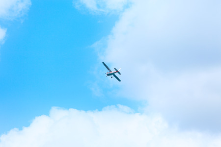 View of  Small plane in the air. Blue sky with white clouds.のeditorial素材