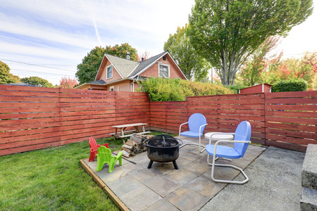 Fenced back yard with patio area and barbecue grill. Northwest, USAの写真素材