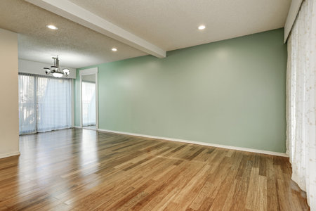 Green and mint interior of empty room with large floor to ceiling windows and shiny hardwood floor...