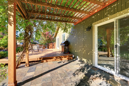 Back yard with pergola , tile floor and wooden walkout deck, Northwest, USA