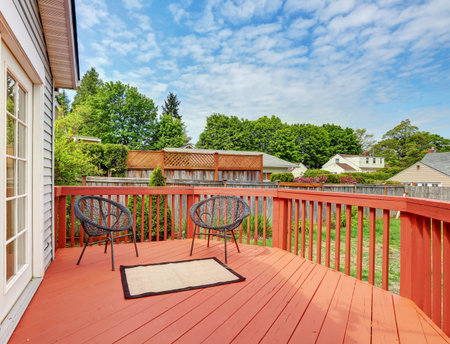 Backyard of craftsman home with red deck. Northwest, USA