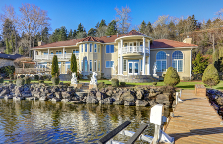 Private dock of luxurious waterfront home with jet ski lifts on a bright sunny day. Lake Washington. Northwest, USAの写真素材