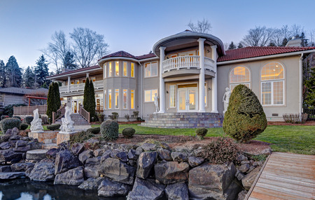Luxurious Mediterranean style waterfront home exterior, sunset view from the deck with rocky coast. Lake Washington. Northwest, USAの写真素材