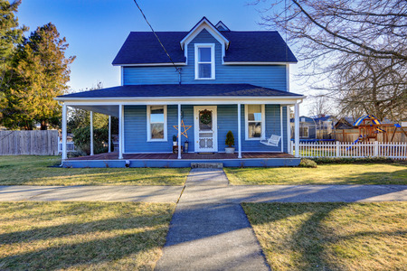 Home exterior with Classic Northwest Charm features blue siding and wrap around front porch. Northwest, USAの写真素材