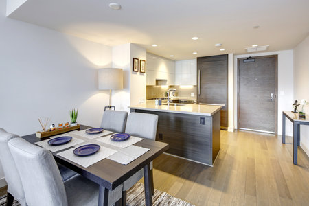 Contemporary apartment design of dining area and compact kitchen in white and grey colors. Northwest, USAの写真素材