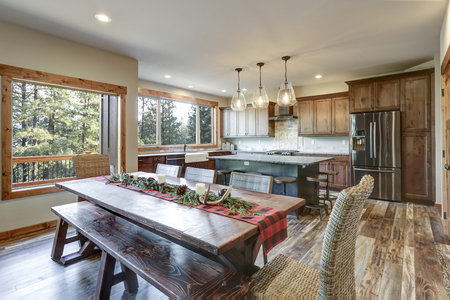 Reclaimed wood trestle dining table decorated for Christmas in a luxury American country house.の写真素材