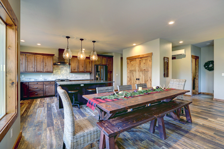 Reclaimed wood trestle dining table decorated for Christmas in a luxury American country house.の写真素材