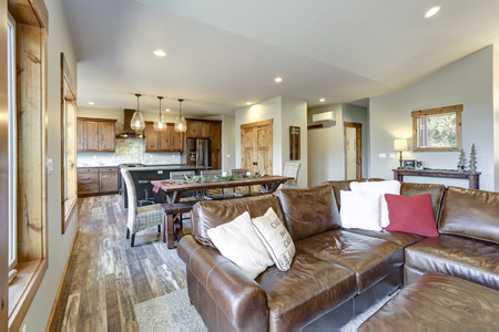 Light and spacious living room interior with open floor plan in American country house.の写真素材
