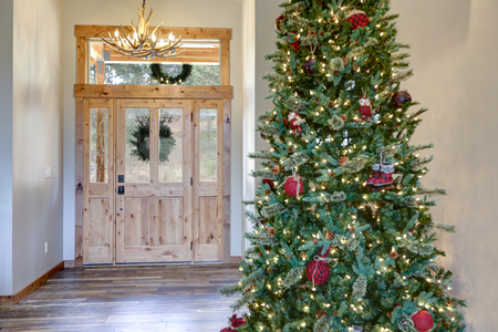 Beautifully decorated Christmas tree in a new luxury house.の写真素材