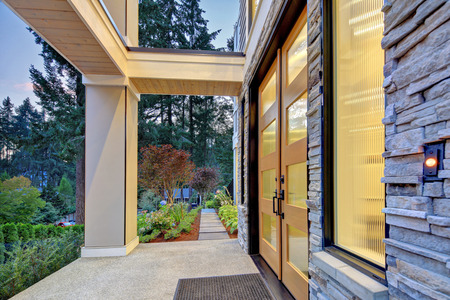 Modern house exterior with high ceiling entrance porch and perfectly designed landscape.の写真素材
