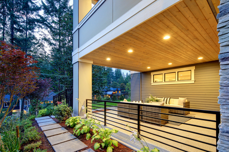 Luxury covered patio with stone fireplace and cozy interiorの写真素材