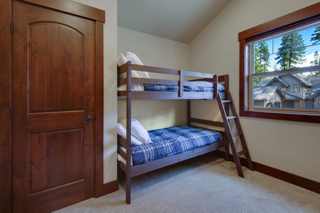 Boys or kids bedroom interior with bunk bed, blue blankets and beige new room wuth carpet and wooden...