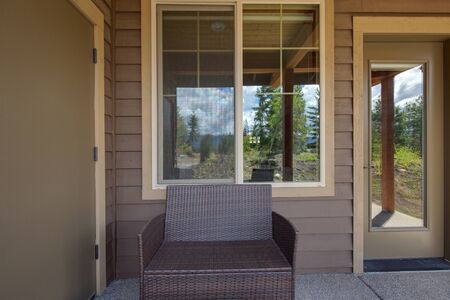 Amazing balcony patio with fire pit and forest and mountains view. Dream come true home exterior. New American architecture. Comfortable and beautiful home details.の写真素材