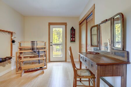 Hobby room  bright interior with wooden antique desk and mirror with chair, country style of American cozy home with light bamboo flooring.の写真素材
