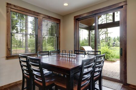 Dining room with dark wood square table and large sliding doorの写真素材
