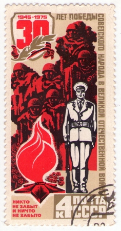 USSR - circa 1975  Soviet collectible postage stamp   Russian soldier standing with arms circa 1975のeditorial素材