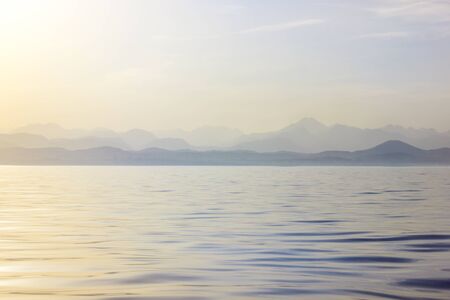 Calm sea in the morning. Waves of the ocean at dawn.の写真素材