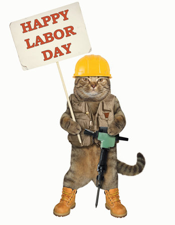 The cat worker is holding a jack hammer and a banner with the text "Happy Labor Day". White background.の写真素材
