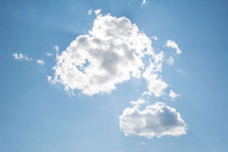 clouds in blue sky, sun light through cloudsの写真素材