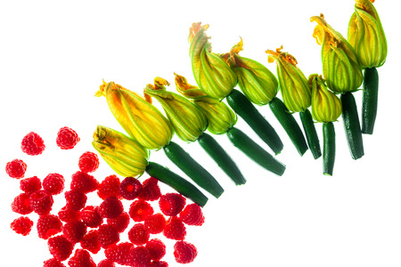 Fresh zucchini flowers top view isolated on white And raspberryの写真素材