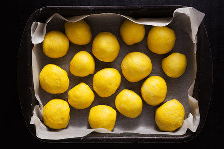 turmeric buns with sesame seeds on baking tray