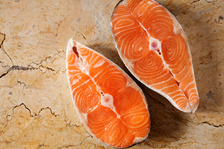 salmon steak on natural marble tableの写真素材