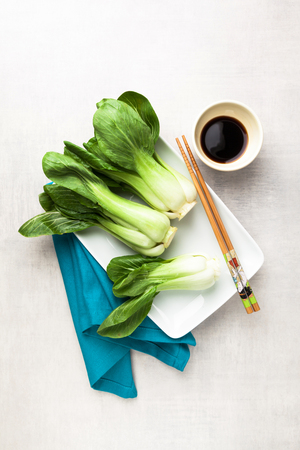 fresh not cooked bok choy and soy sauce on the table. Chinese chopsticks. Asian cuisines ingredientの写真素材