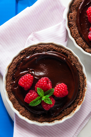 Chocolate raspberry tarts mint leavesの写真素材