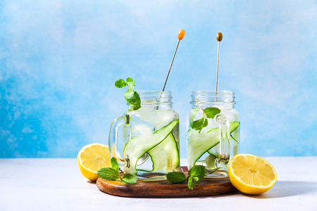Cold and refreshing infused detox water with lime and cucumber in a glassの写真素材
