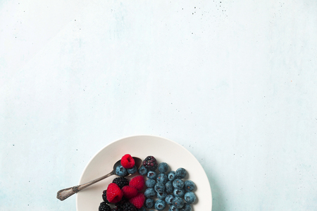 Fruit salad with Various fresh summer berries in white plate . Top viewの写真素材
