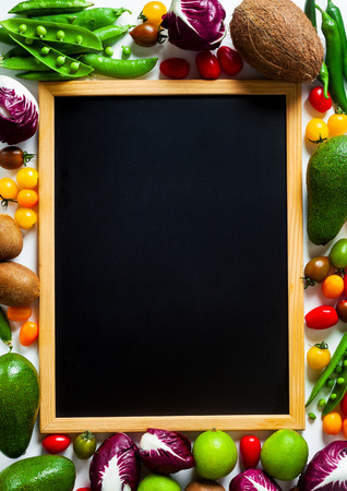 slate board for writing as copy space and different vegetables and fruits background. summer harvestの写真素材