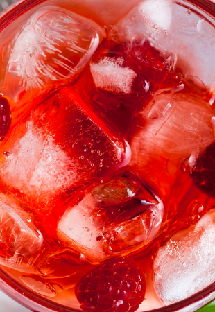 closeup photo of raspberries drink with ice . red macro food background の写真素材