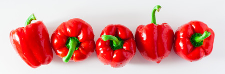 banner of group of red ripe organic bell pepper  isolated on white. copy space の写真素材