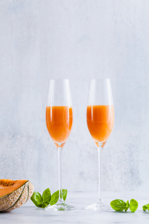 Italian Bellini alcoholic cocktail made from sweet ripe melon with basil flavor. Ideal drink for snacksの写真素材