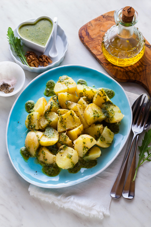 young potatoes, steamed, with pesto of arugula and nuts. tasty healthy summer food.の写真素材