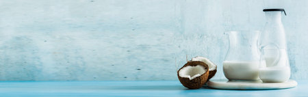 banner of natural, homemade coconut milk in a glass jar, jar and glass. and halves of chopped...