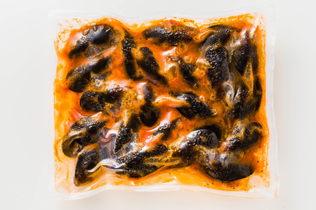 Frozen mussels in a package isolated on whiteの写真素材