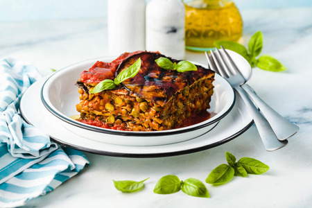 gluten free vegan lasagna. from grilled eggplant, green peas, lentils and vegetables. delicious healthy comfort food for the whole family for the holidays. italian parmigianaの写真素材