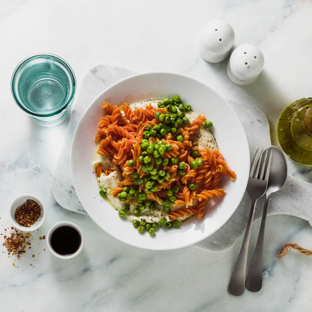 gluten-free healthy vegan red lentil pasta with green peas and cauliflower puree with garlic. tasty mac and cheese fusilli  for celiac diseaseの写真素材