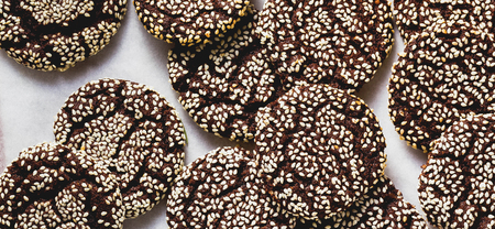 banner of Christmas chocolate cookies with sesame and New Year's festive decorations on the tableの写真素材