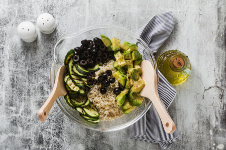salad with rice with zucchini, avocado, olives and capers. healthy spring summer vegan cuisine recipe for the whole family or partyの写真素材